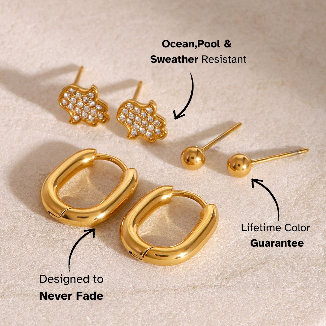 Simple gold ball studs for sensitive ears, elegant and timeless design on textured surface.