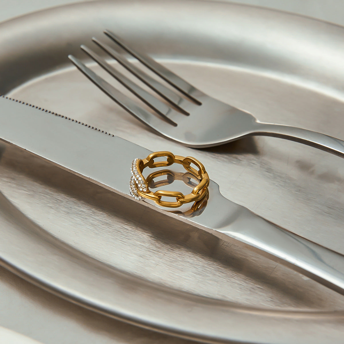 Statement gold-plated ring with pavé zircon detail, photographed under natural light.