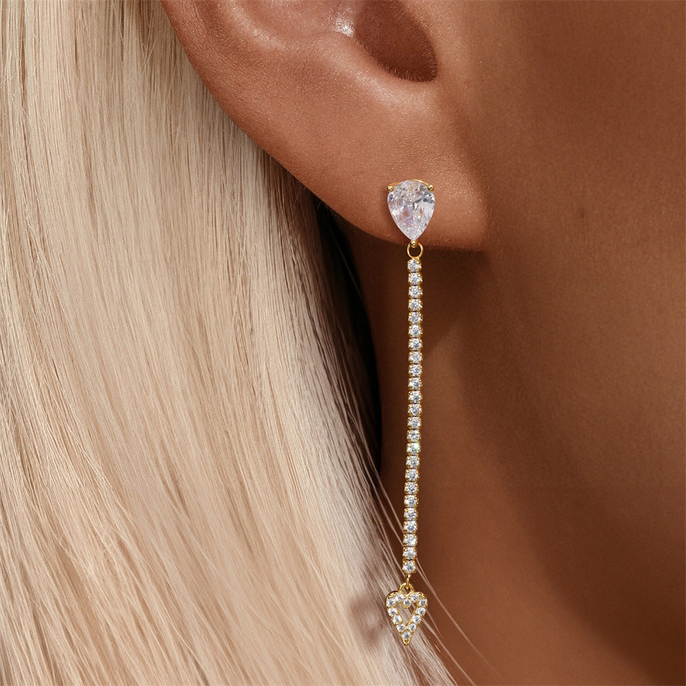 Shorter version of the gold earrings styled as hoops, shown on model with sleek hairstyle