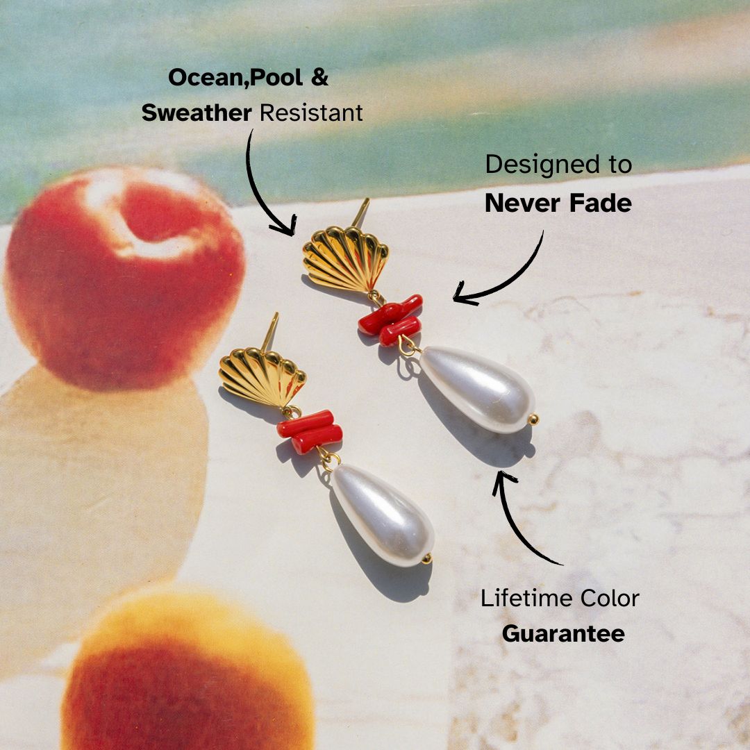 Gold shell earrings with coral and pearl accents on beach backdrop – lightweight waterproof earrings for summer holiday looks