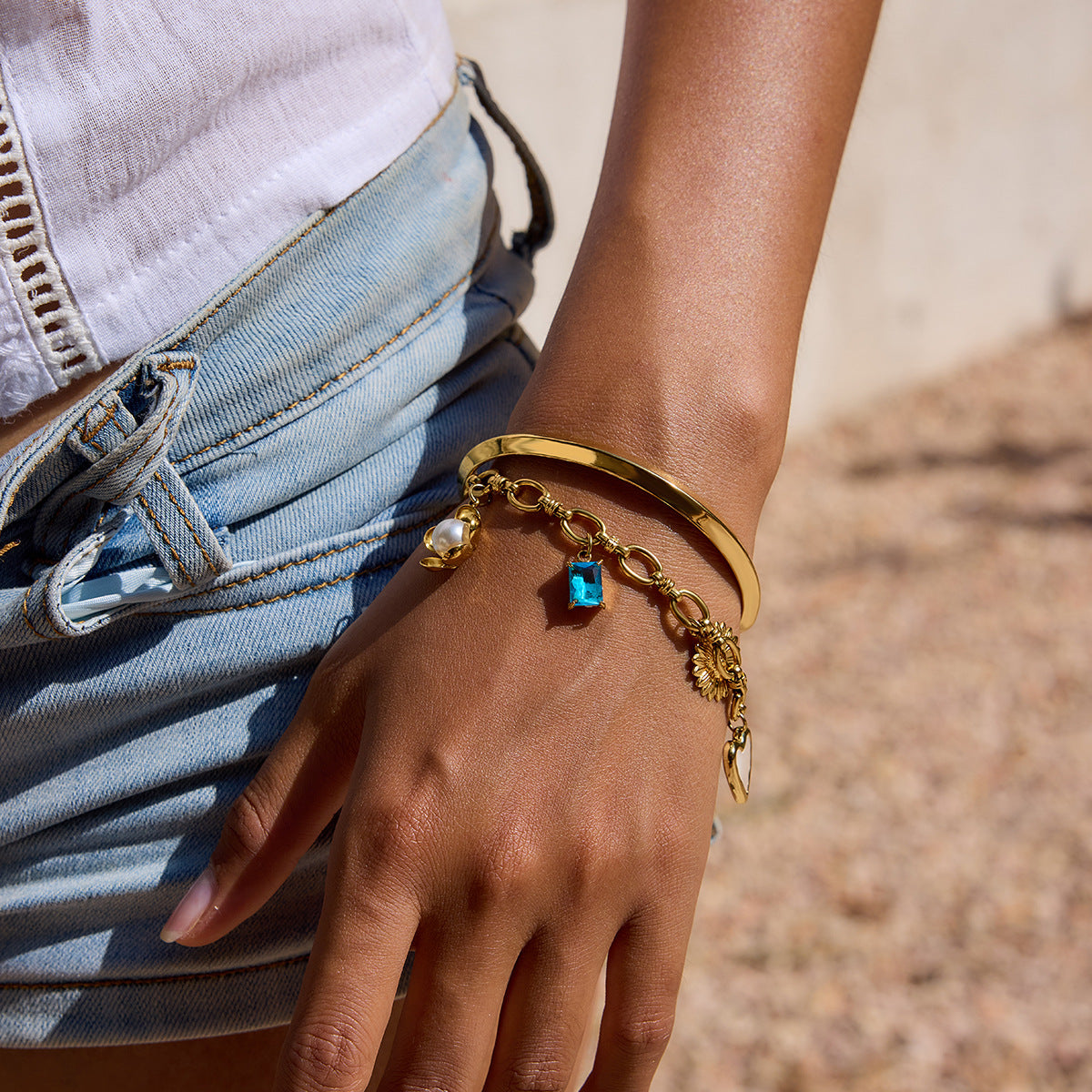 Charm bracelet styled with denim shorts for summer vacation look