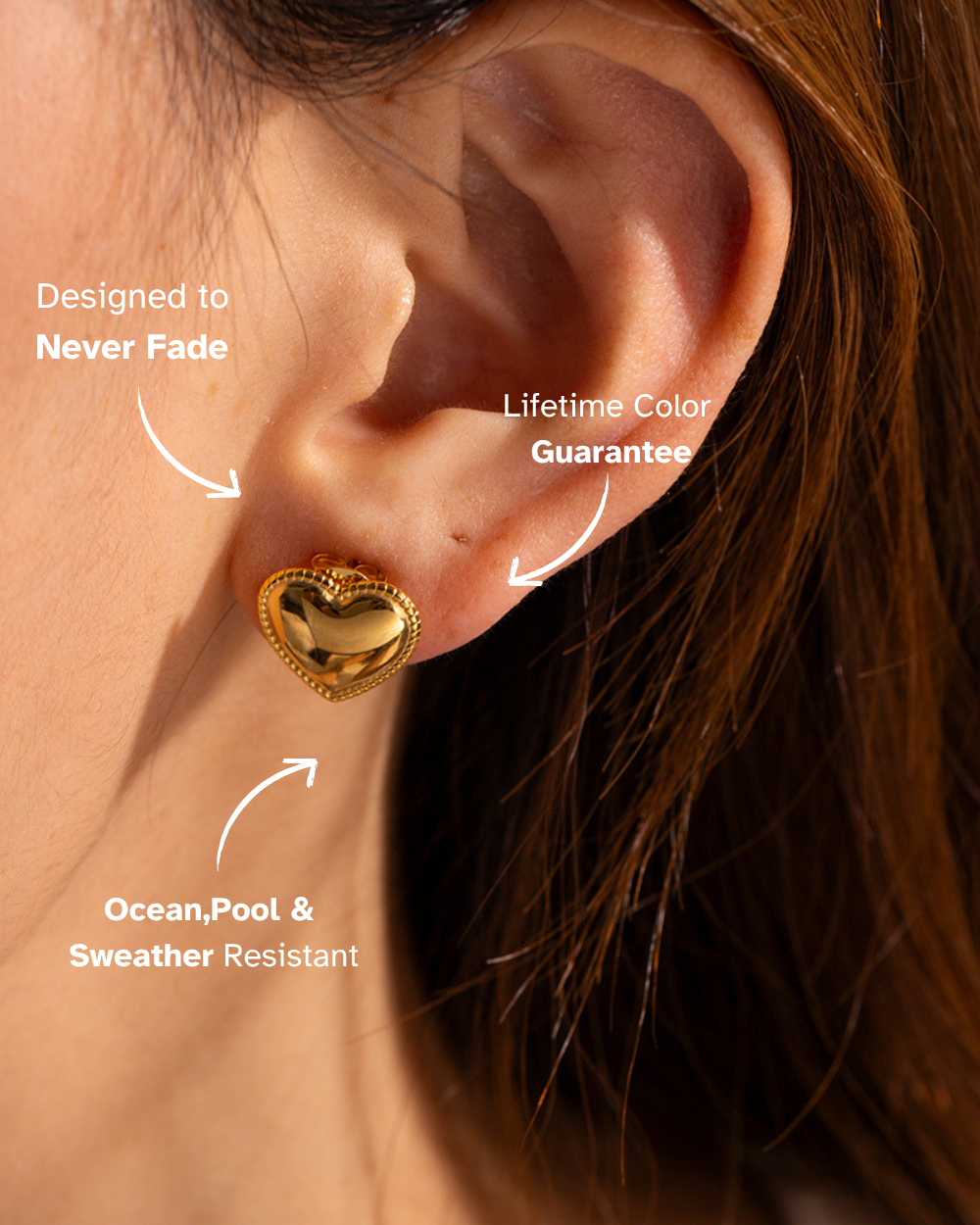 Gold heart-shaped earring worn on an ear with text highlighting features.