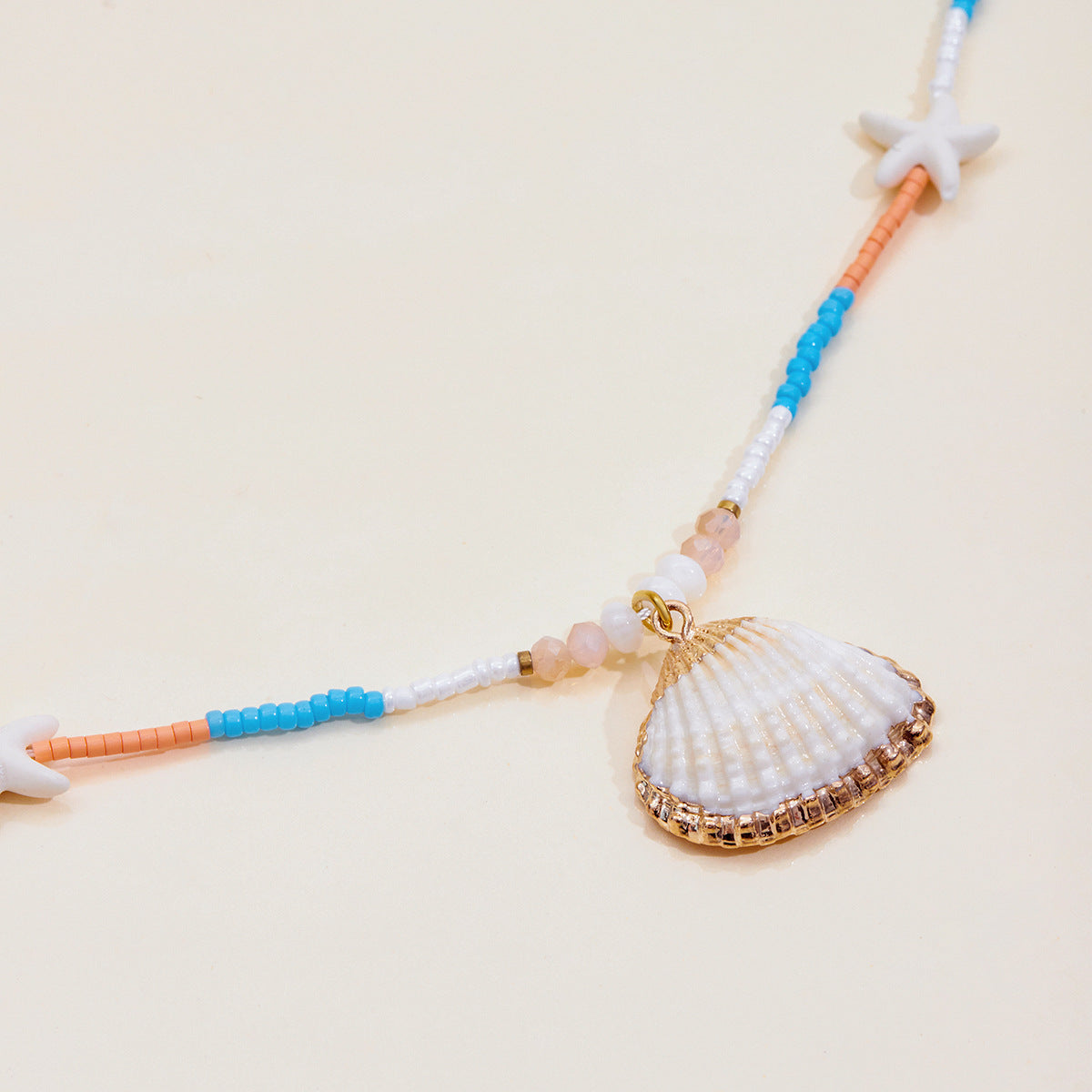 Fun and playful beach necklace with white shell pendant and colorful seed beads