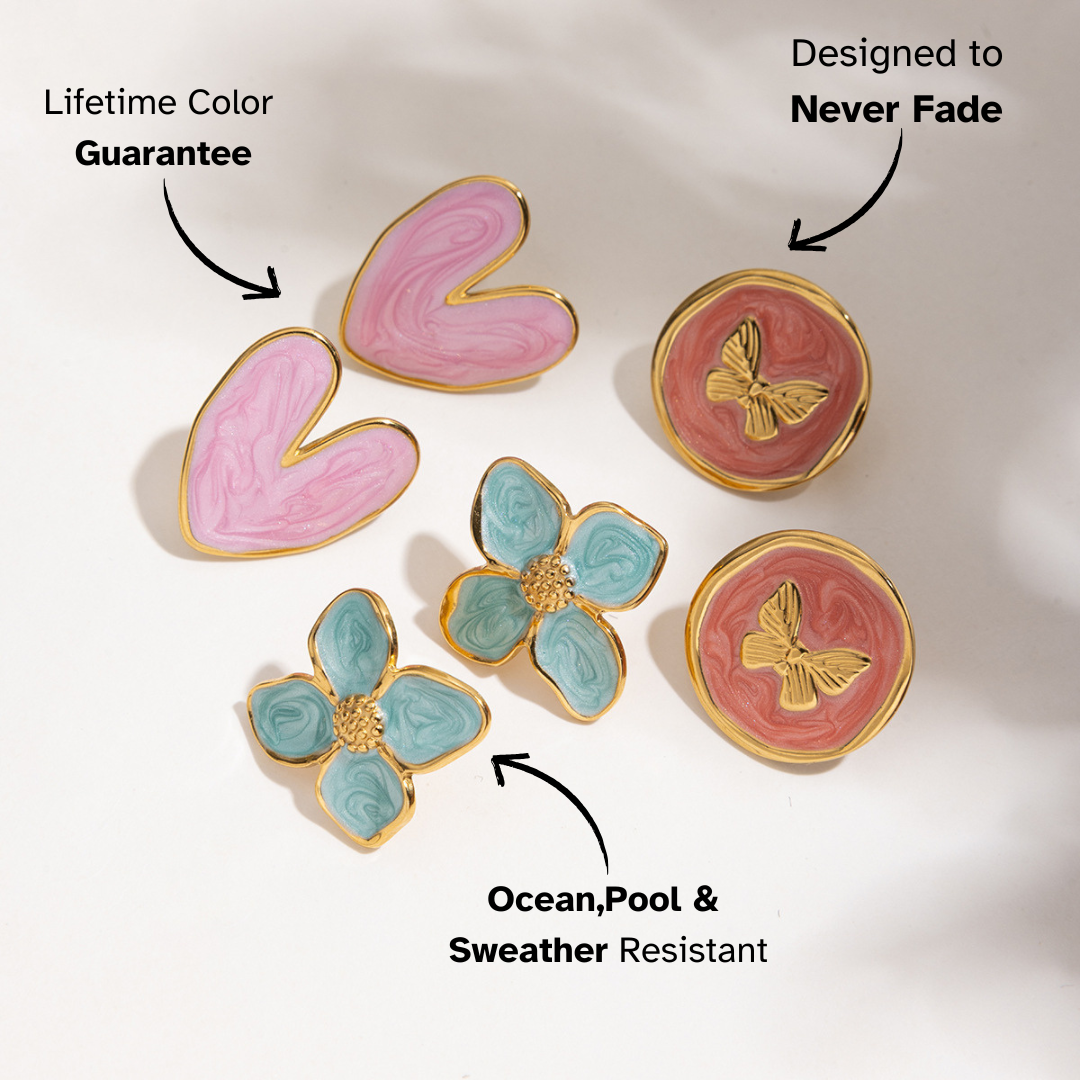Flatlay of colorful mismatched earrings on pastel green box