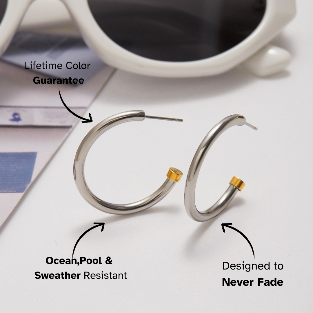 Silver hoop earrings with gold accents on a white surface with text highlighting features.