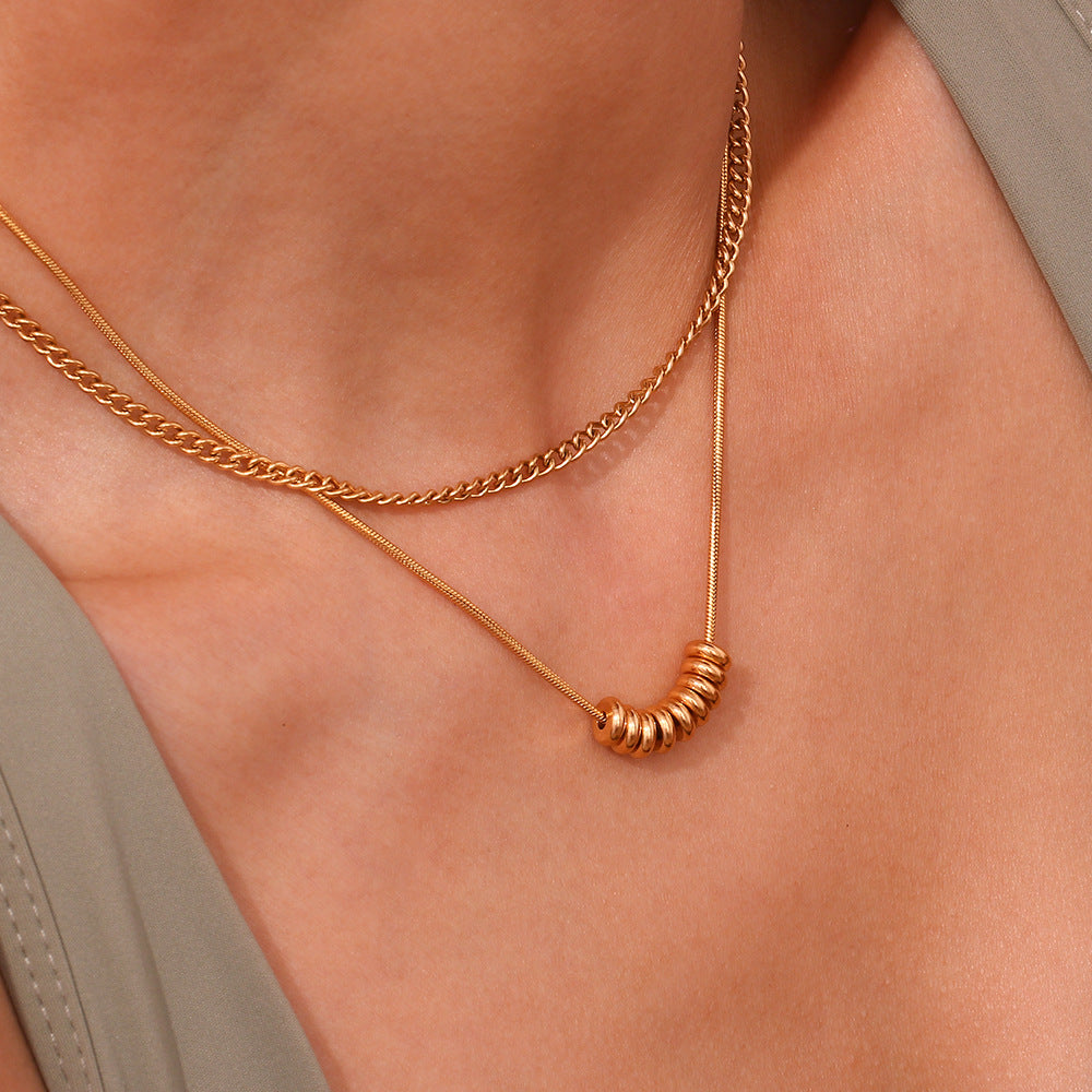 Model wearing bead bar necklace layered over white tee for everyday chic