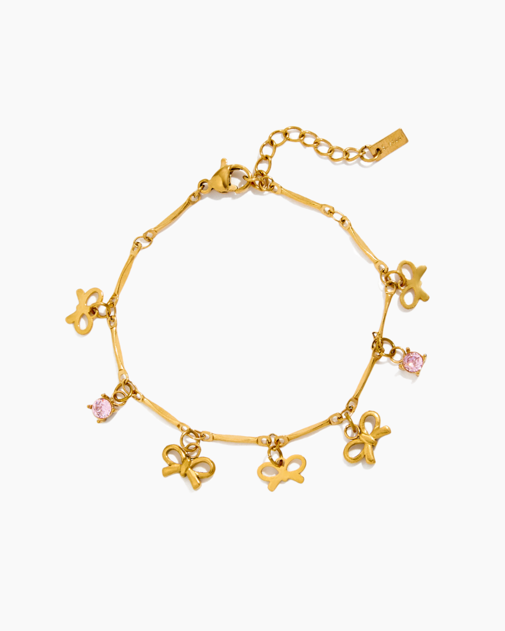Gold bracelet with bow-shaped charms and pink gemstones on a white background