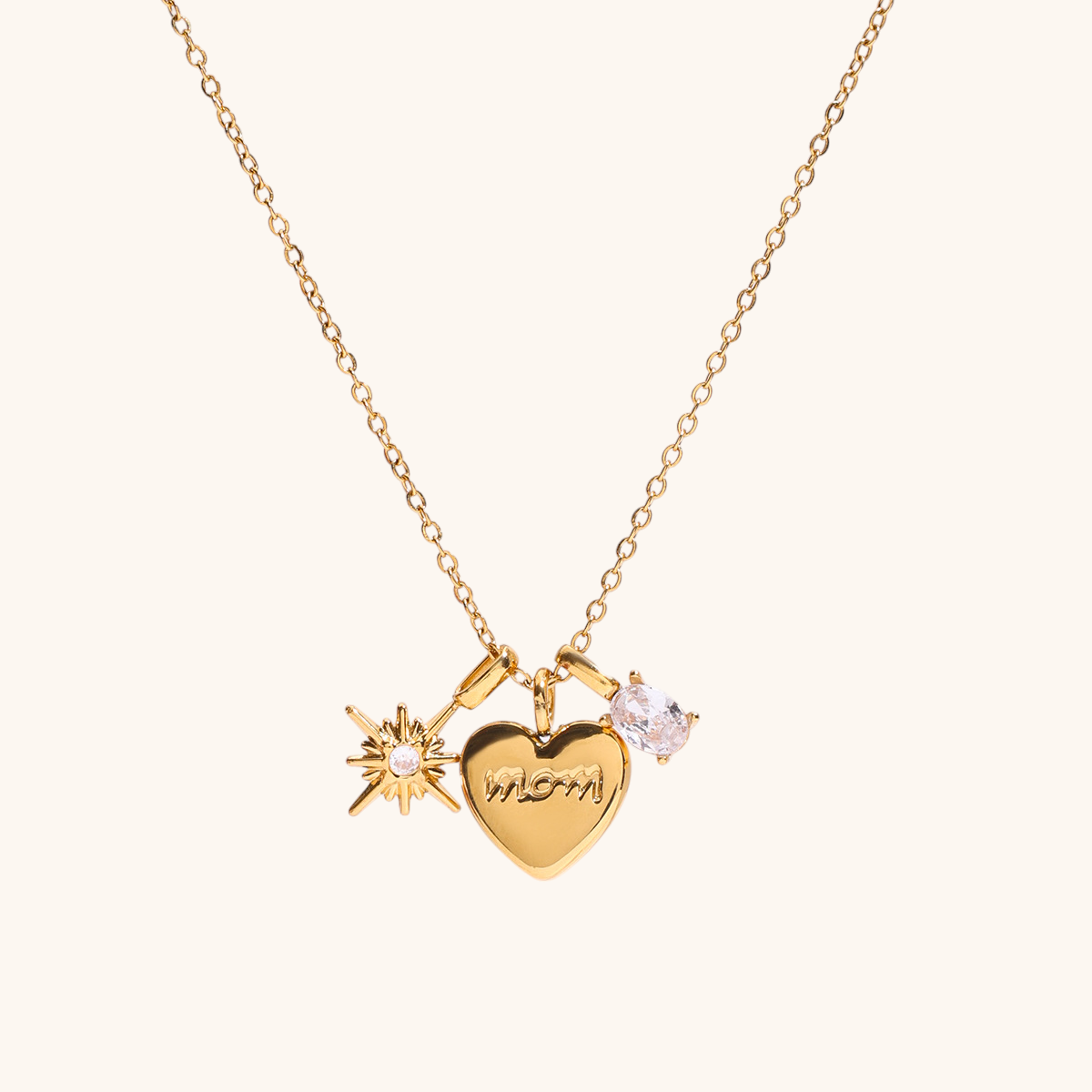 Delicate gold necklace with heart, star, and gem charms on light background