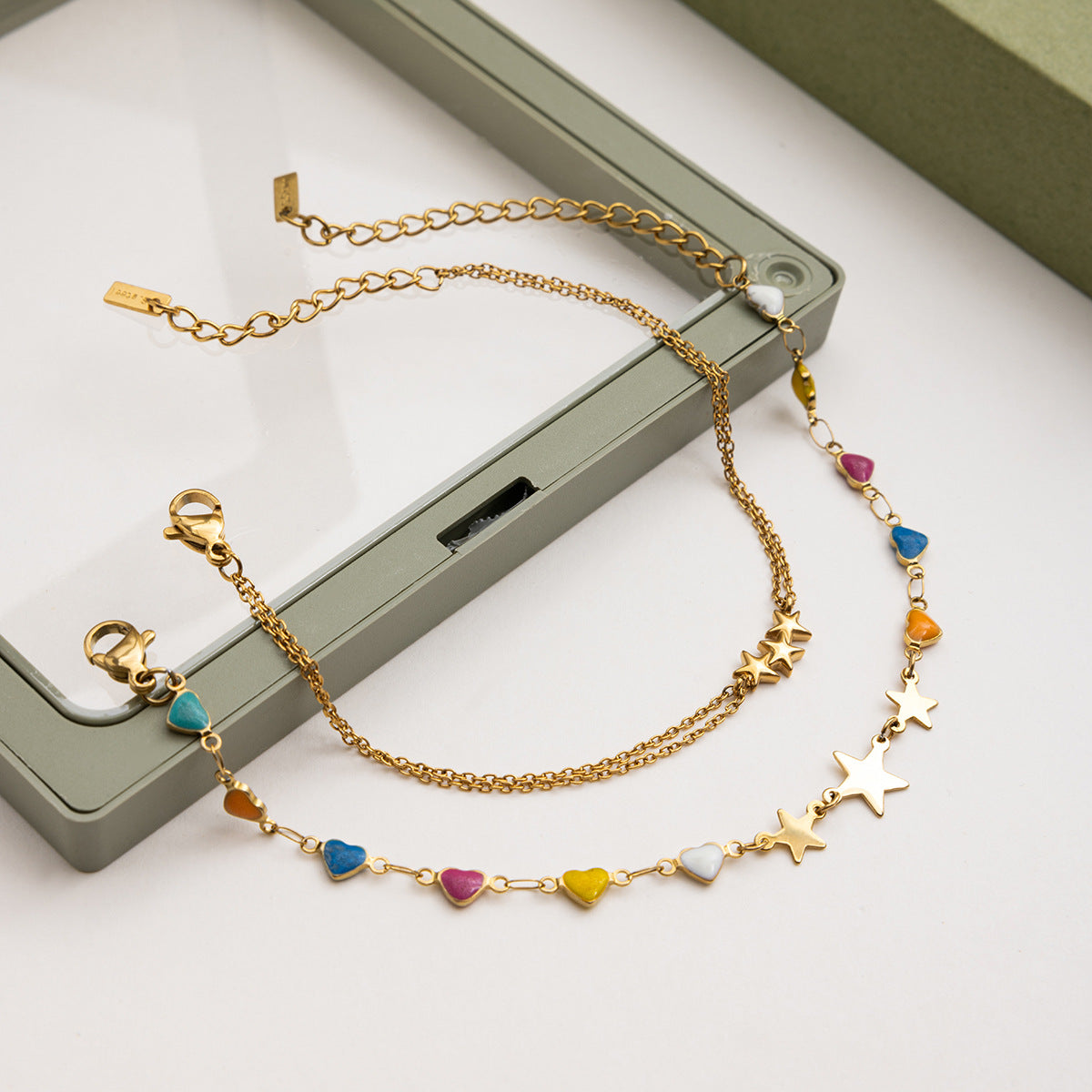 Starlight gold bracelet with enamel heart beads in outdoor summer setting