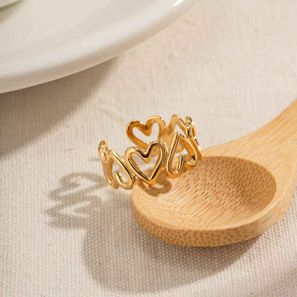 Minimal gold wave ring with cubic zirconia, worn at the beach.