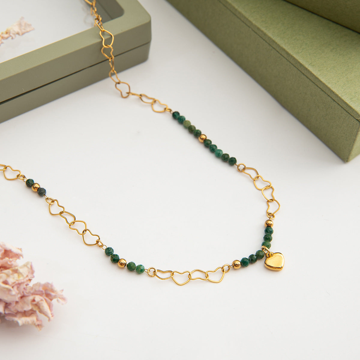 Green and gold waterproof necklace styled for casual outdoor wear