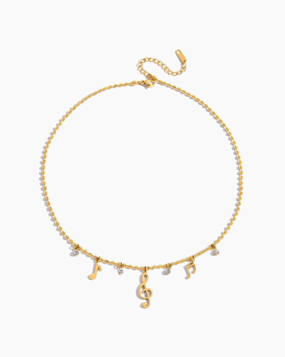 Gold necklace with musical note charms on a white background