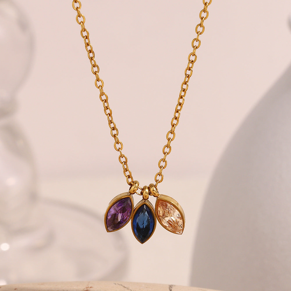 Elegant gold chain necklace featuring three colorful navette-cut stones