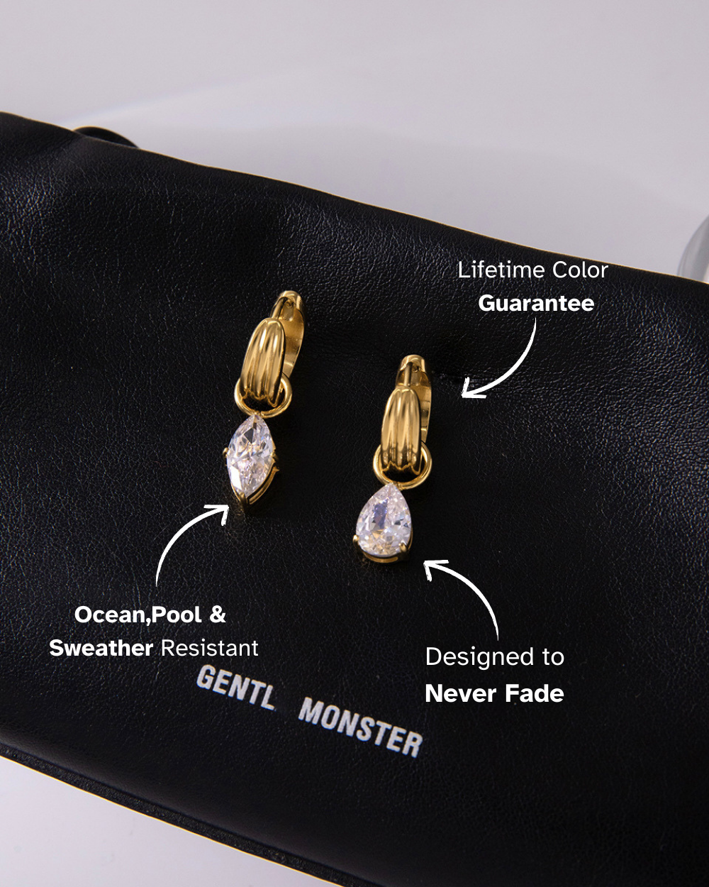 Gold and diamond earrings on a black surface with product features highlighted.