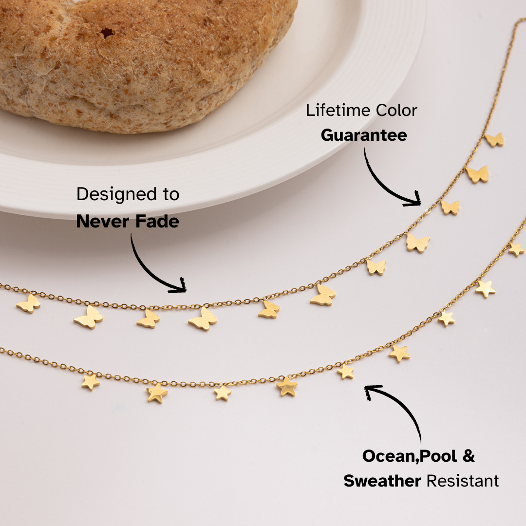 Gold necklace with star pendants on a white surface, with text highlighting features.
