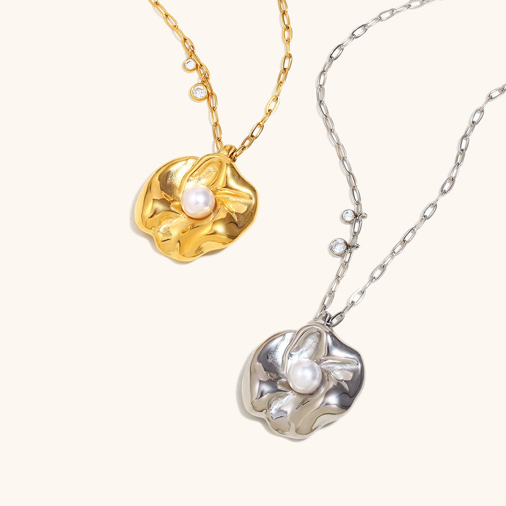 Gold and silver flower necklaces with pearls hanging on branch for display