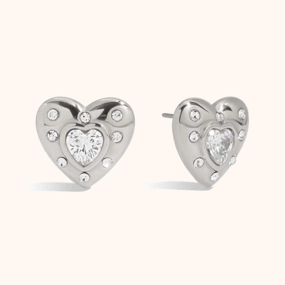 Silver heart earrings with center stone shown on model, perfect for work or date night