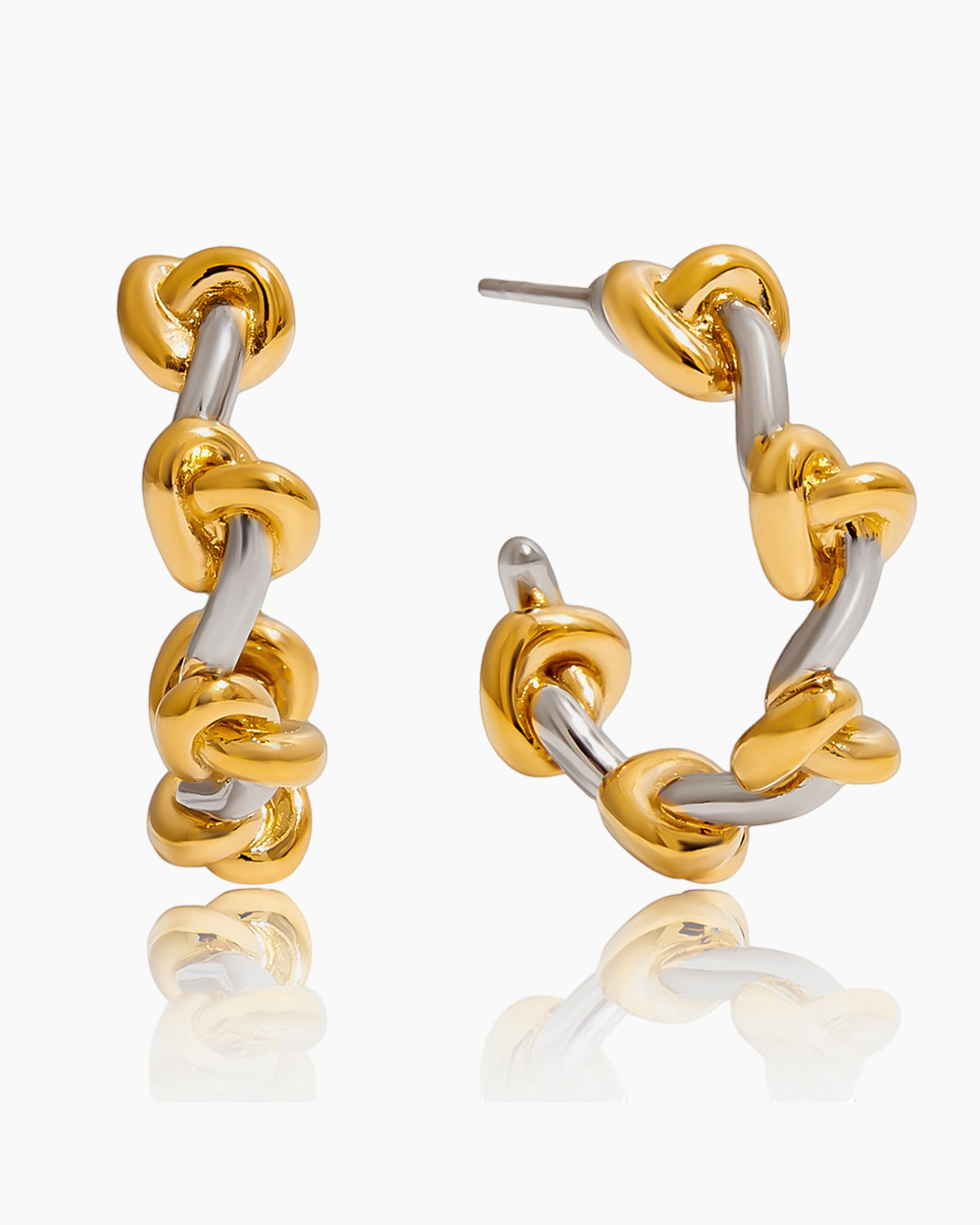 Gold and silver hoop earrings on a white background