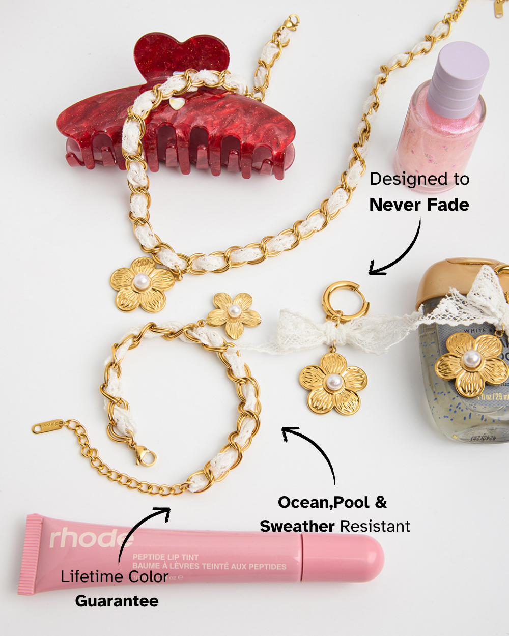 Gold chain with floral pendants, red hair clips, pink lip balm, and bottle on a white background.