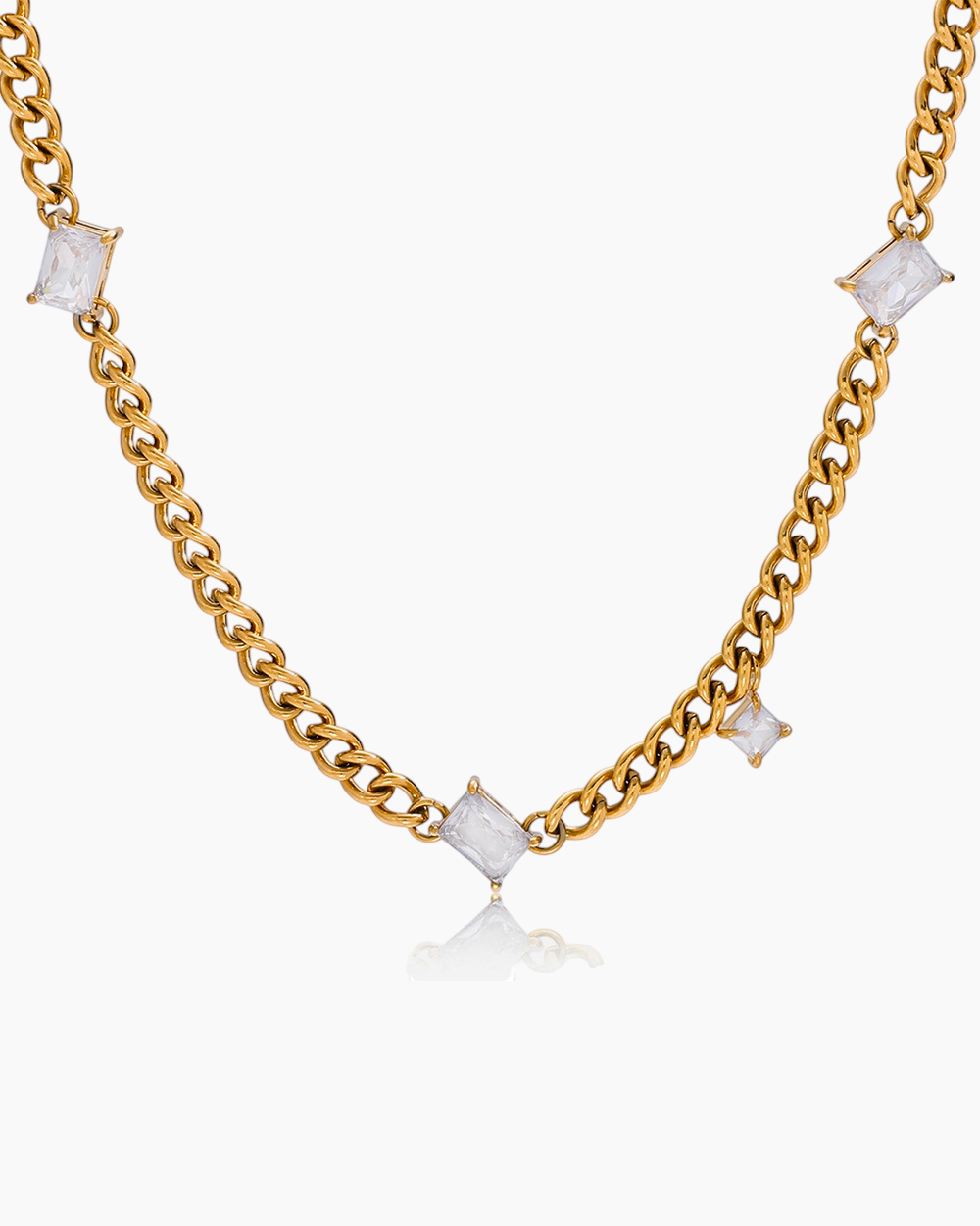 Gold chain necklace with square-shaped white stones on a white background