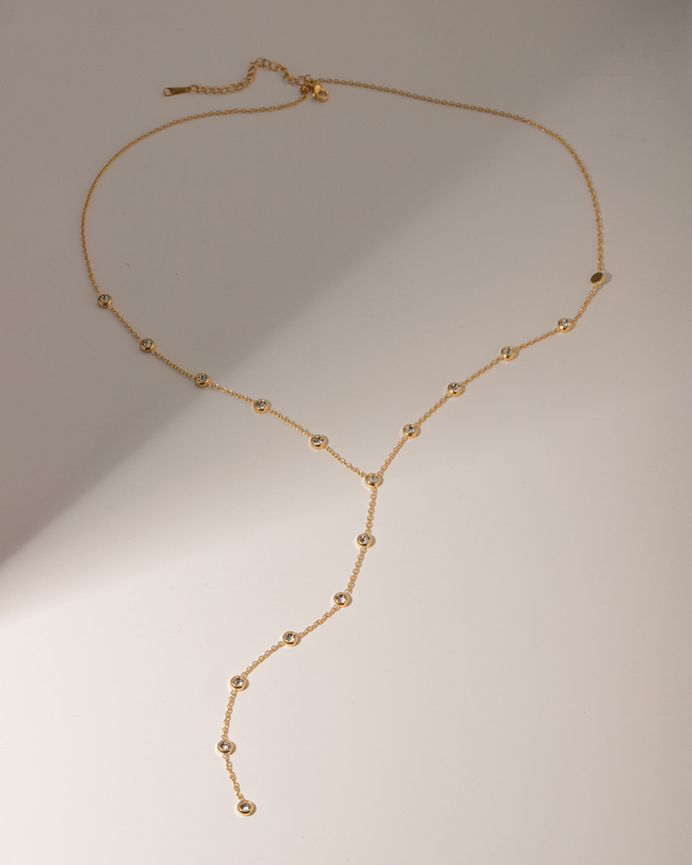 Gold necklace on a beige background