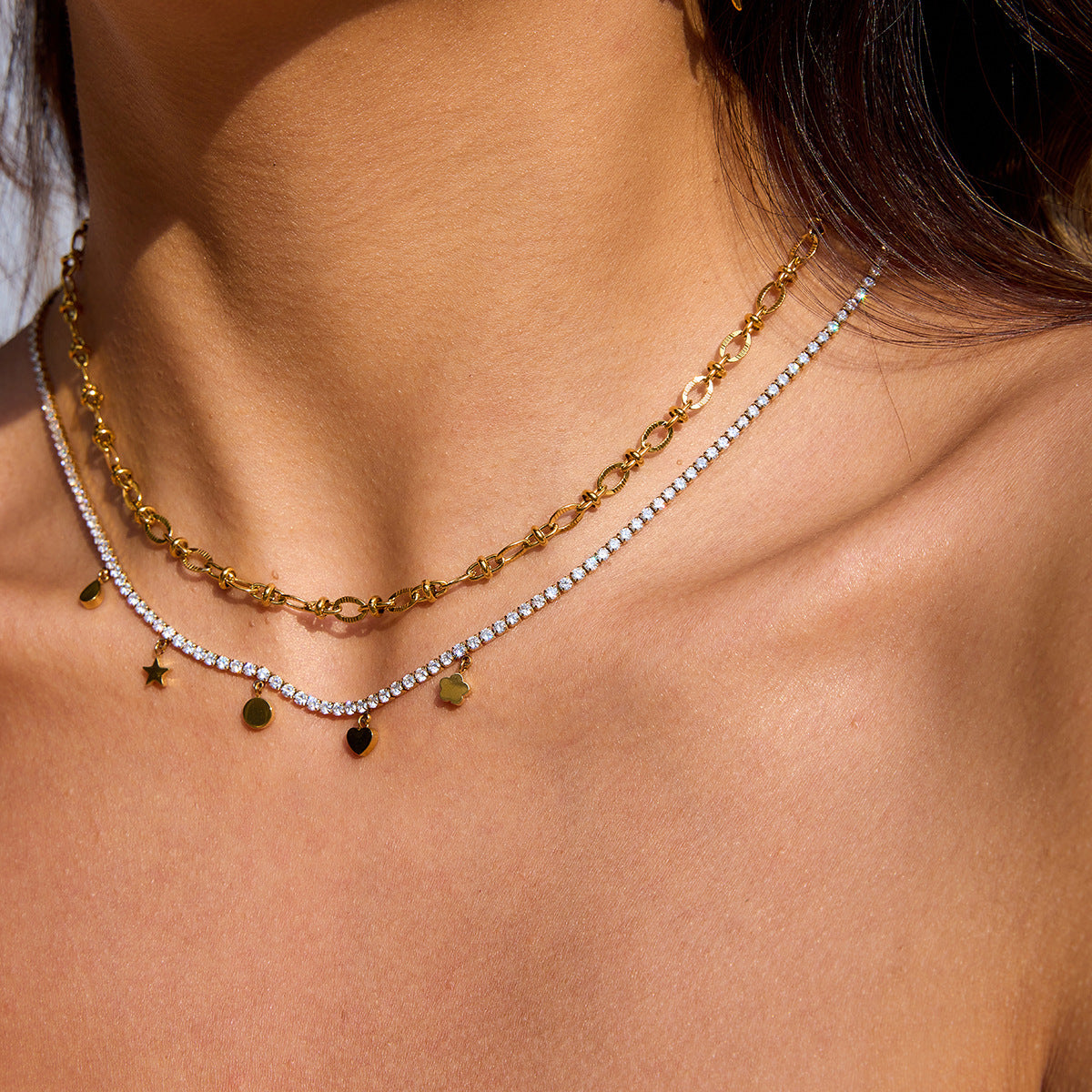 Woman layering gold sculpted chain with a rhinestone drop charm necklace_MiFJewelry