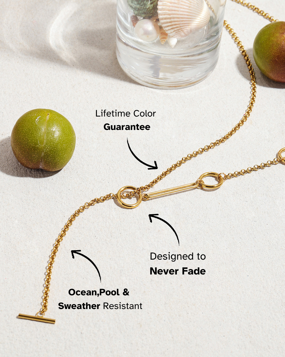 Gold necklace on a white surface with text highlighting features