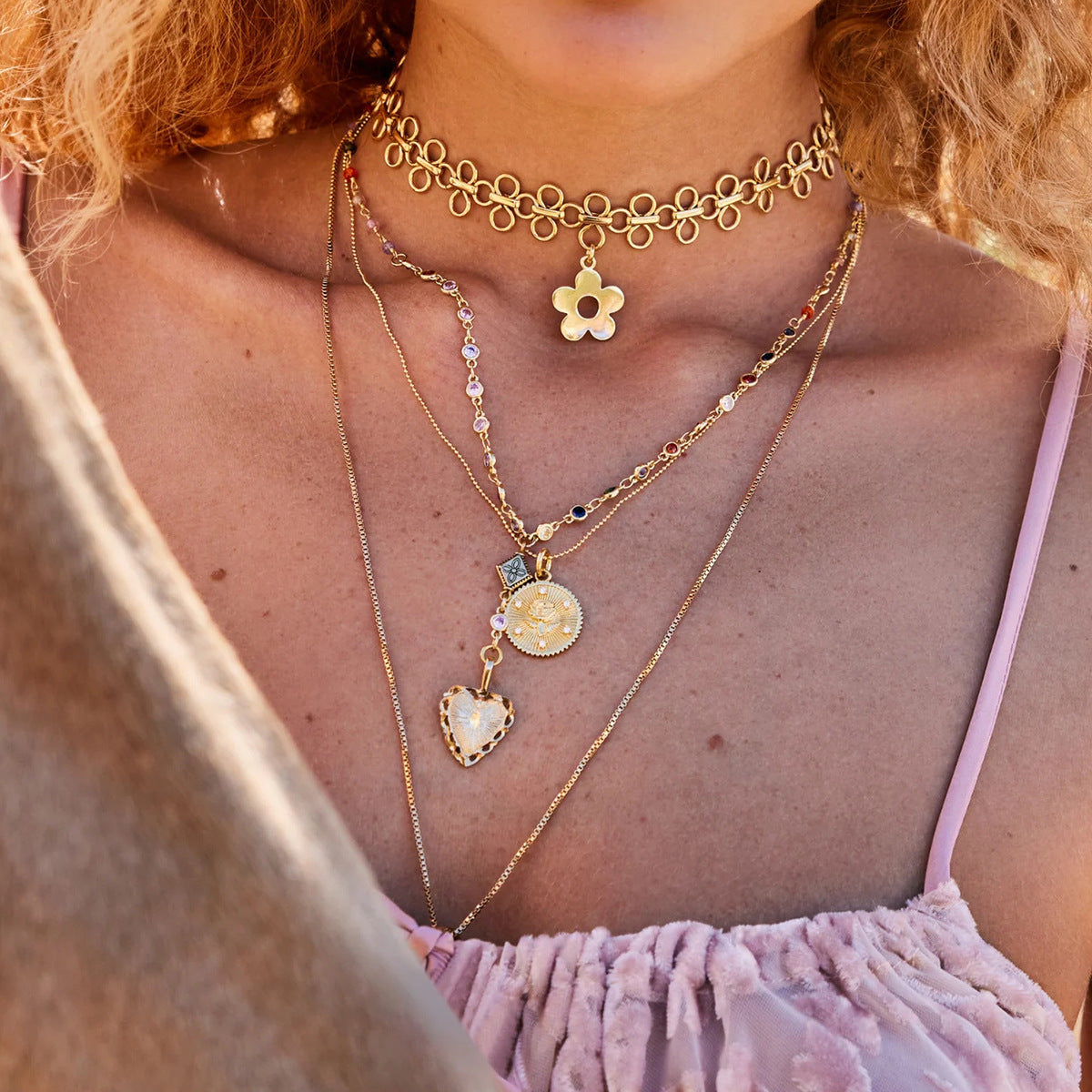 Minimalist flower necklace close to collarbone in natural sunlight