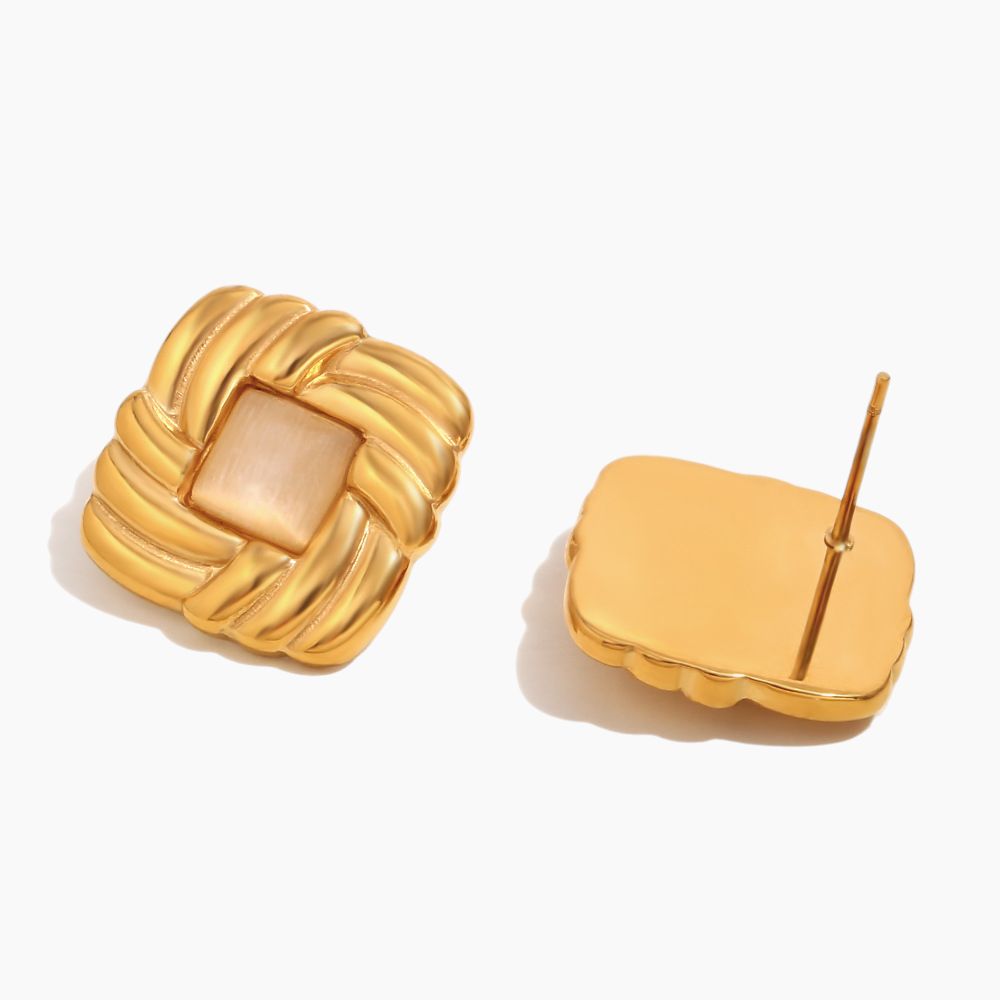 Gold knot earrings on a white background