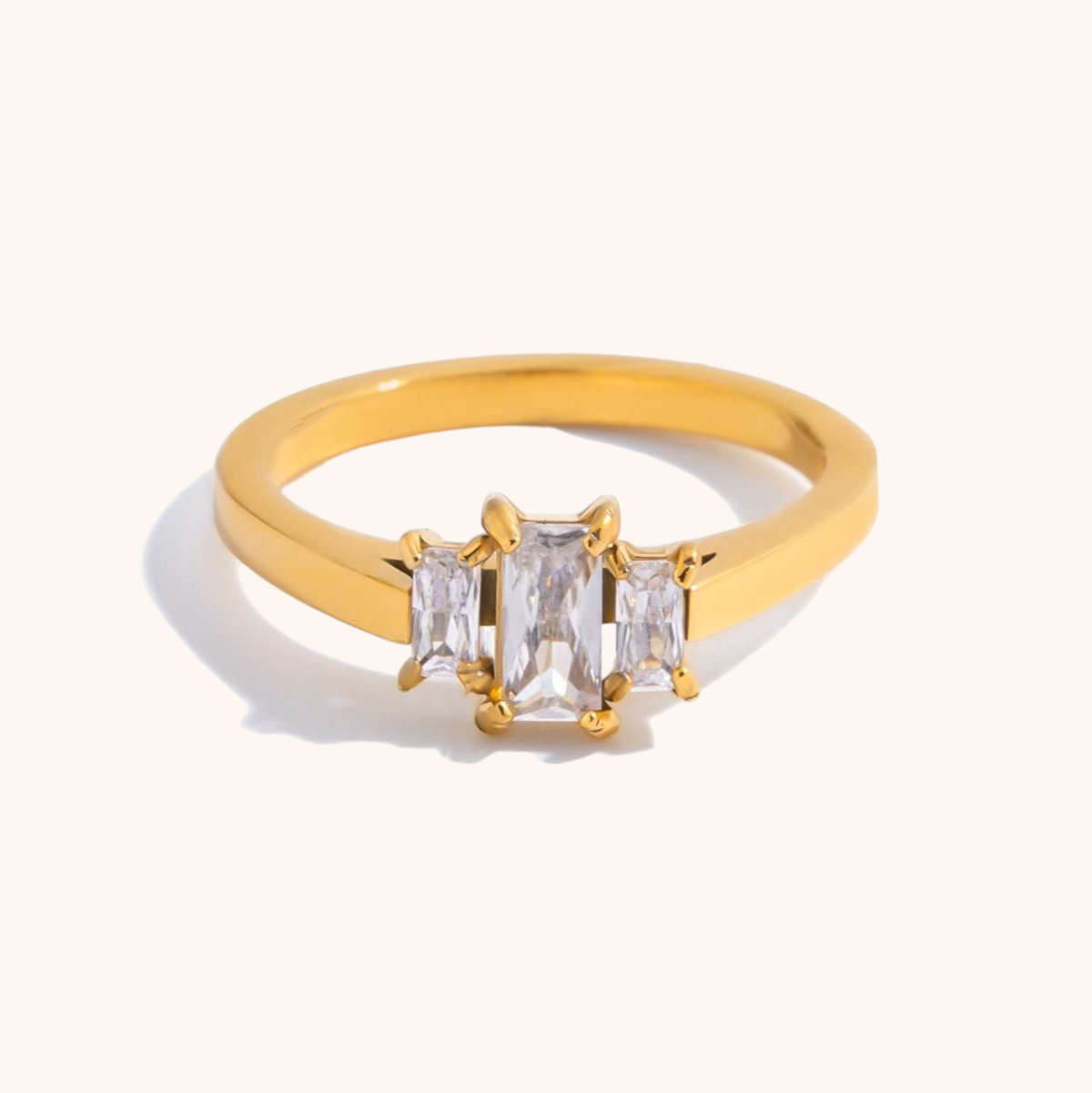 Elegant gold ring with emerald-cut and baguette stones