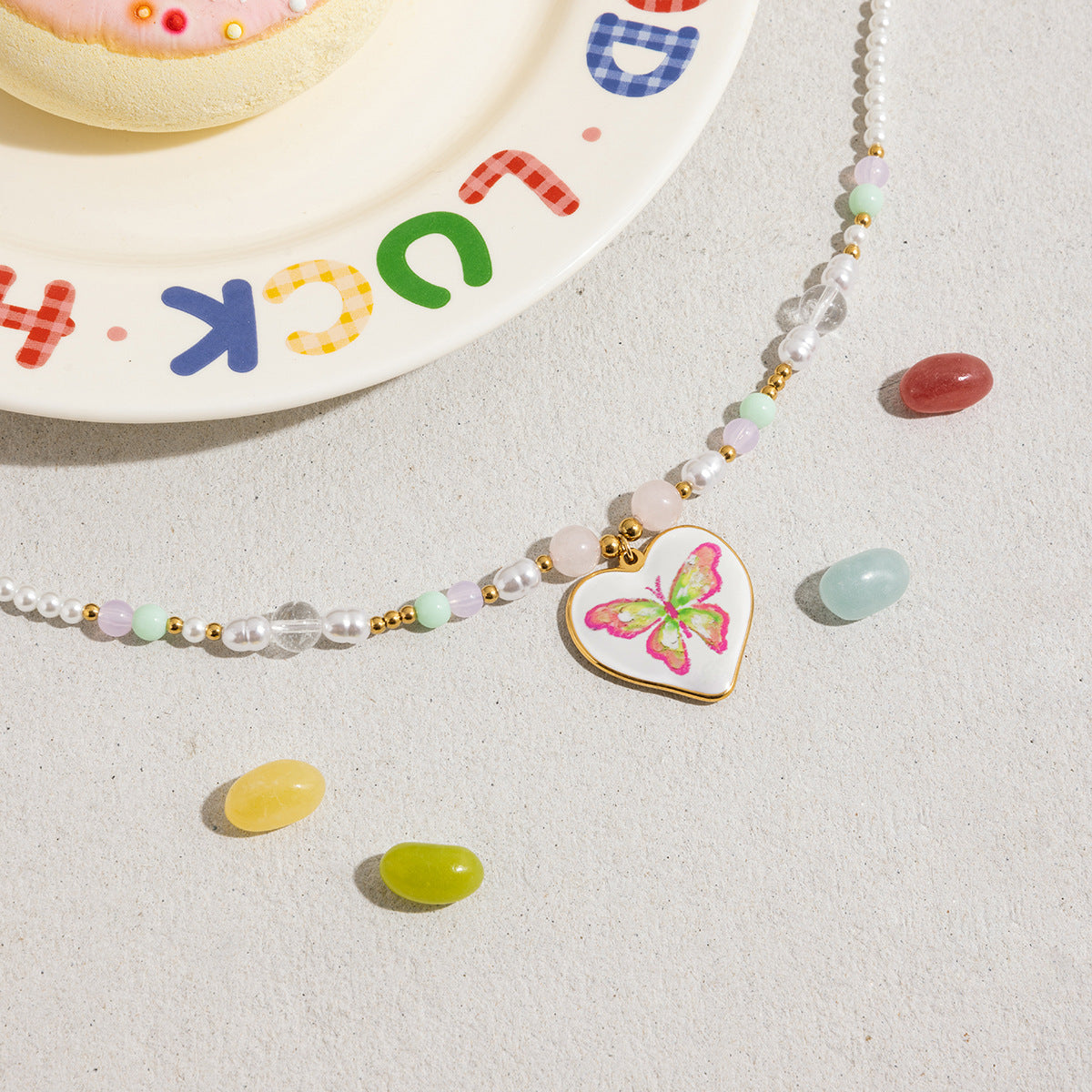 Waterproof beaded necklace with butterfly heart charm close-up