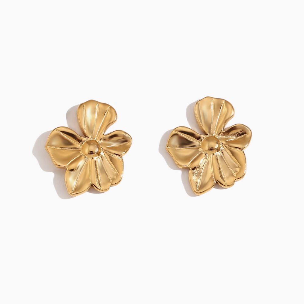 Gold floral earrings on a white background