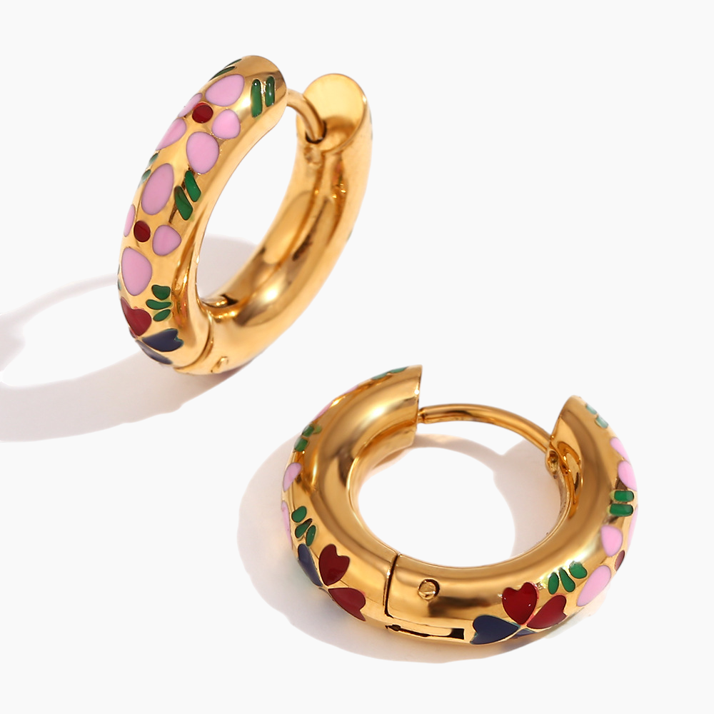 Gold hoop earrings with colorful floral designs on a white background