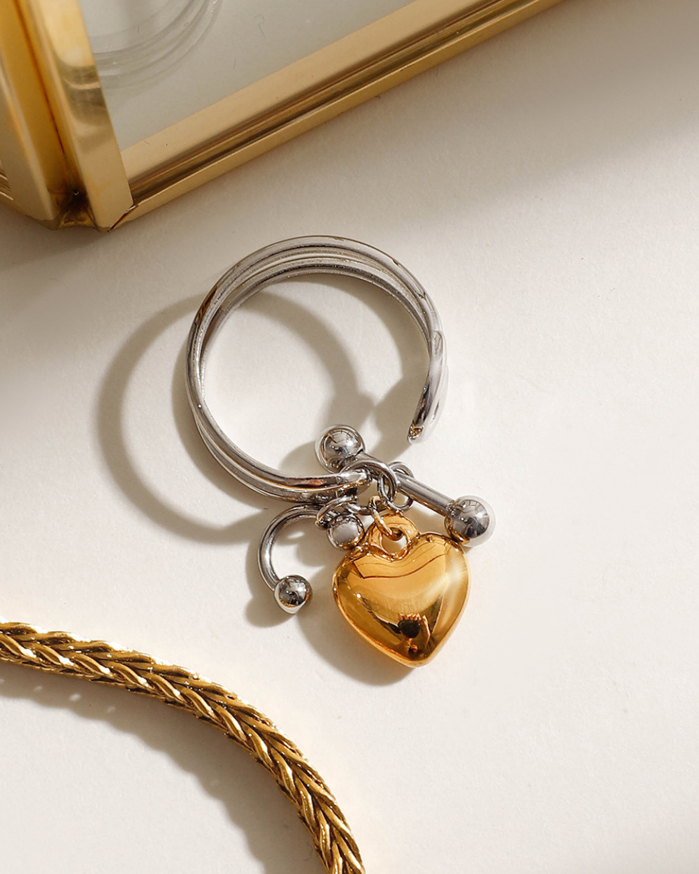 Silver keychain with a heart-shaped charm on a light surface