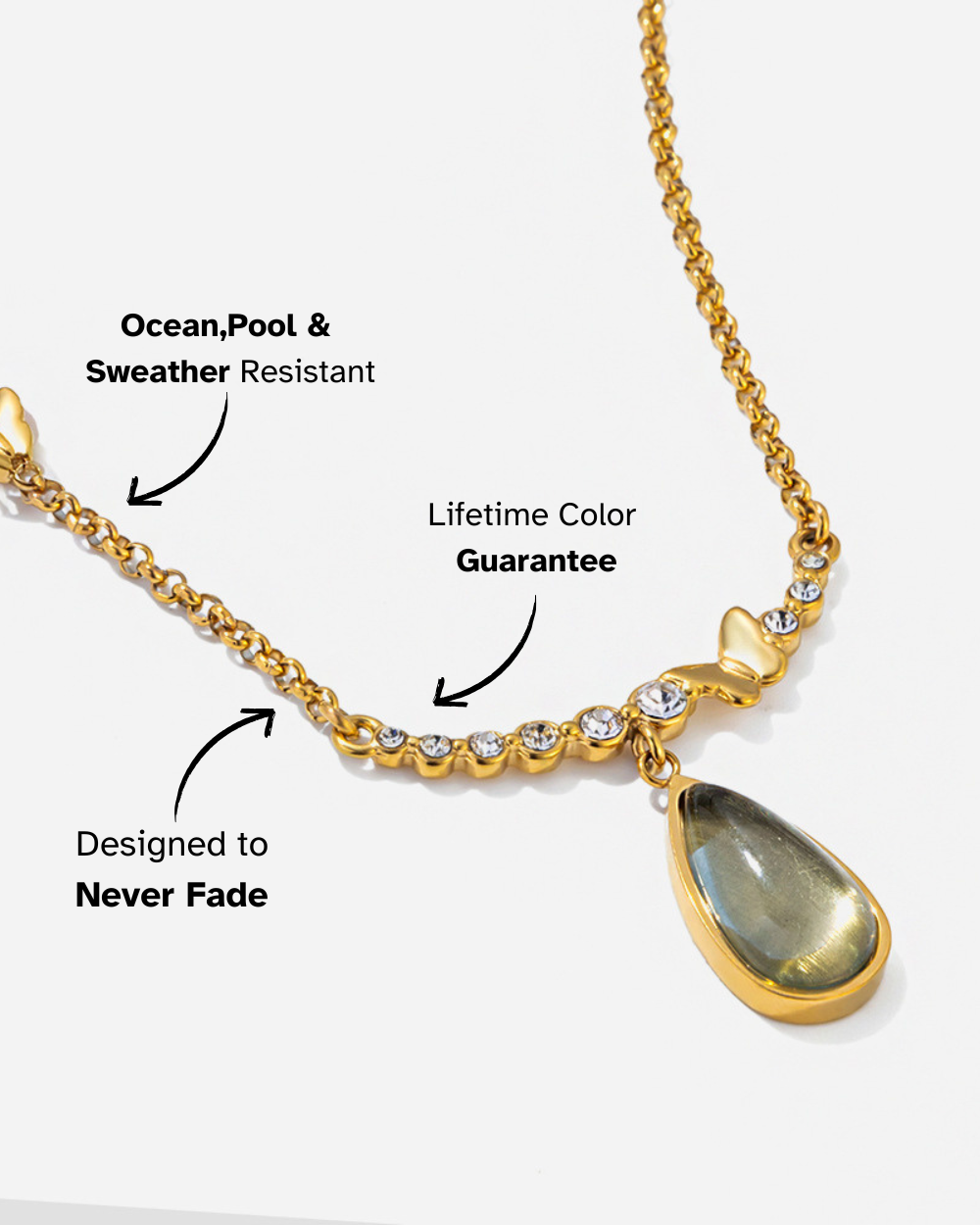 Gold necklace with a teardrop pendant on a white background