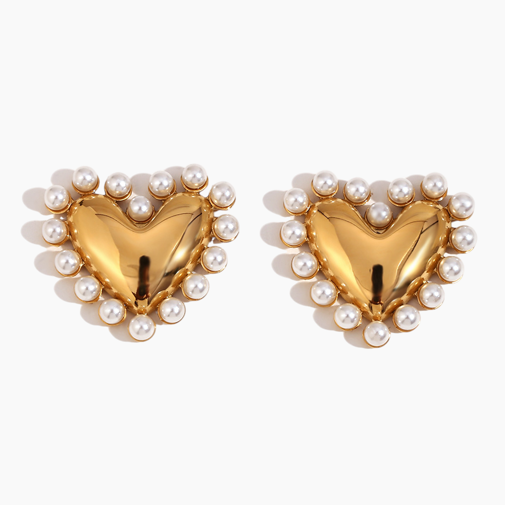 Gold heart-shaped earrings with pearl accents on a white background