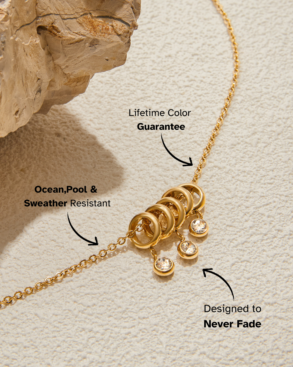Gold necklace with text highlighting features on a textured beige background