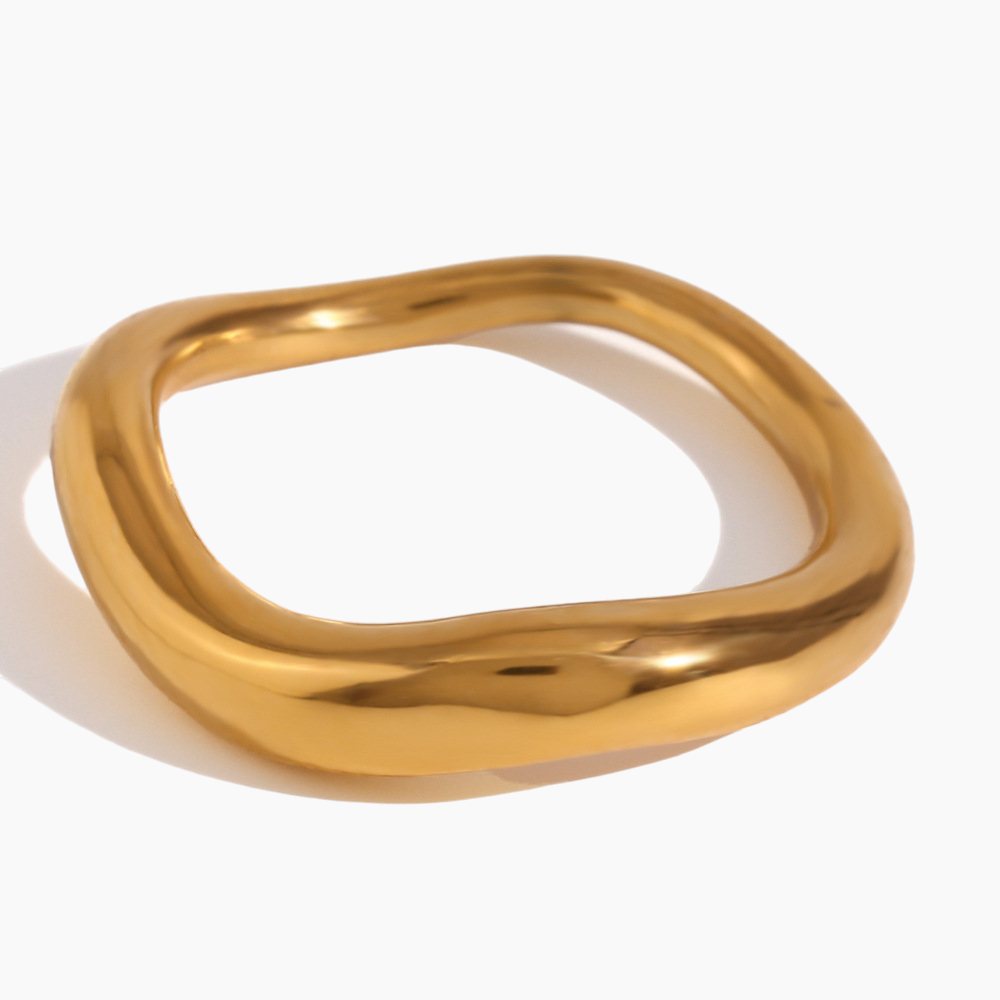 Gold ring with a unique design on a white background