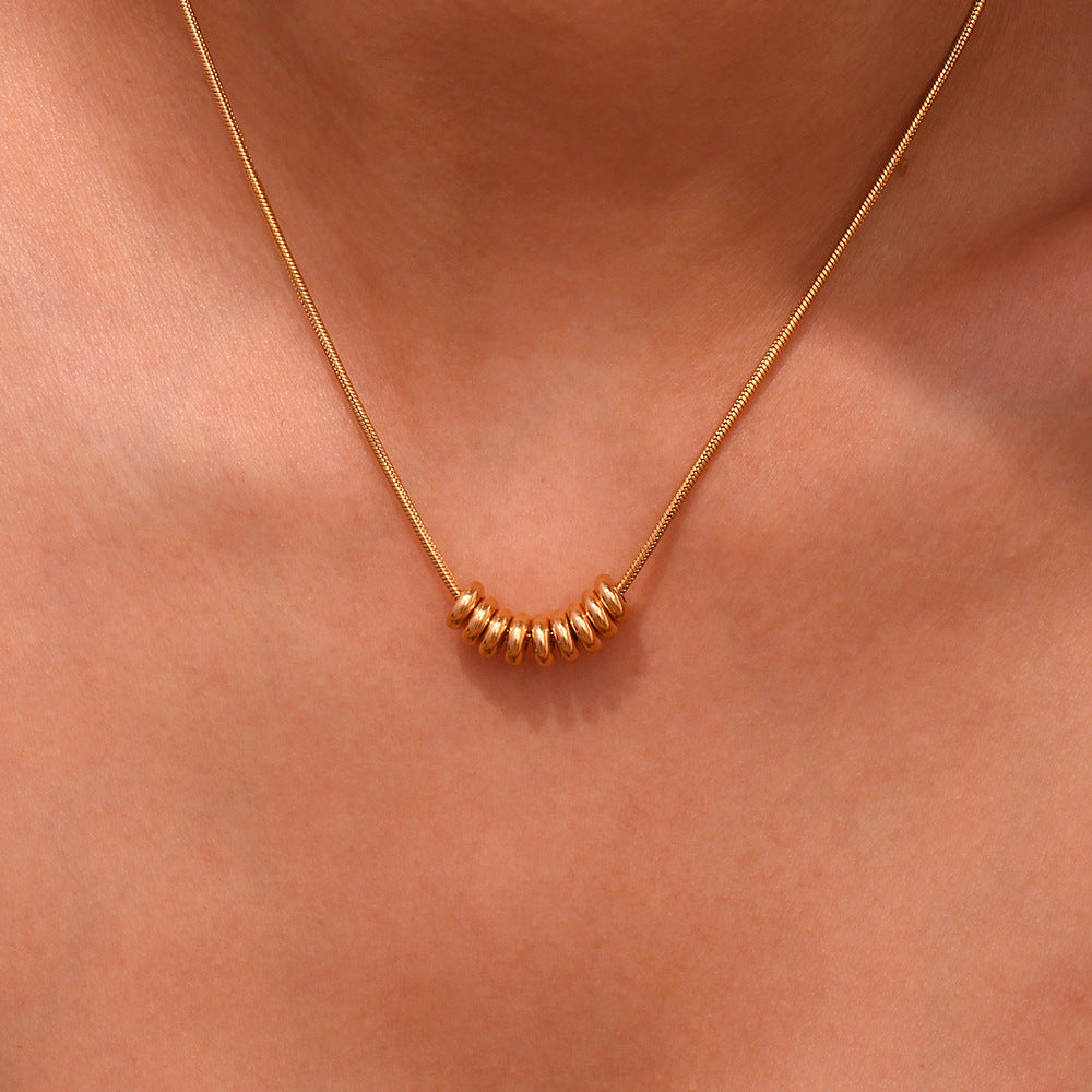 Detailed view of small round beads strung horizontally on necklace