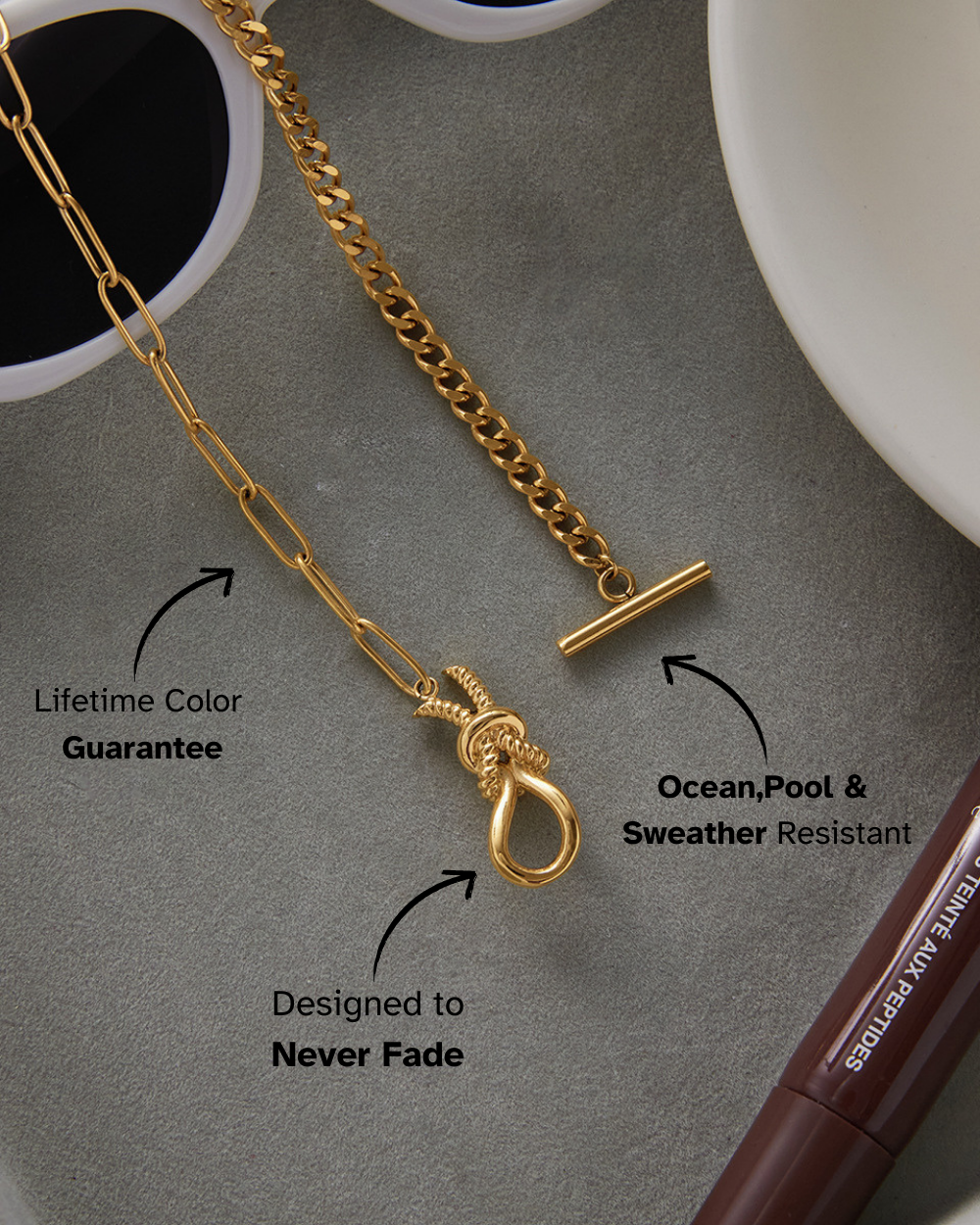 Gold chain necklace with pendant on a gray surface, featuring text about product features.