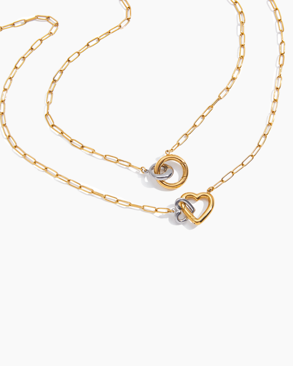 Gold chain necklace with heart-shaped clasp on a white background