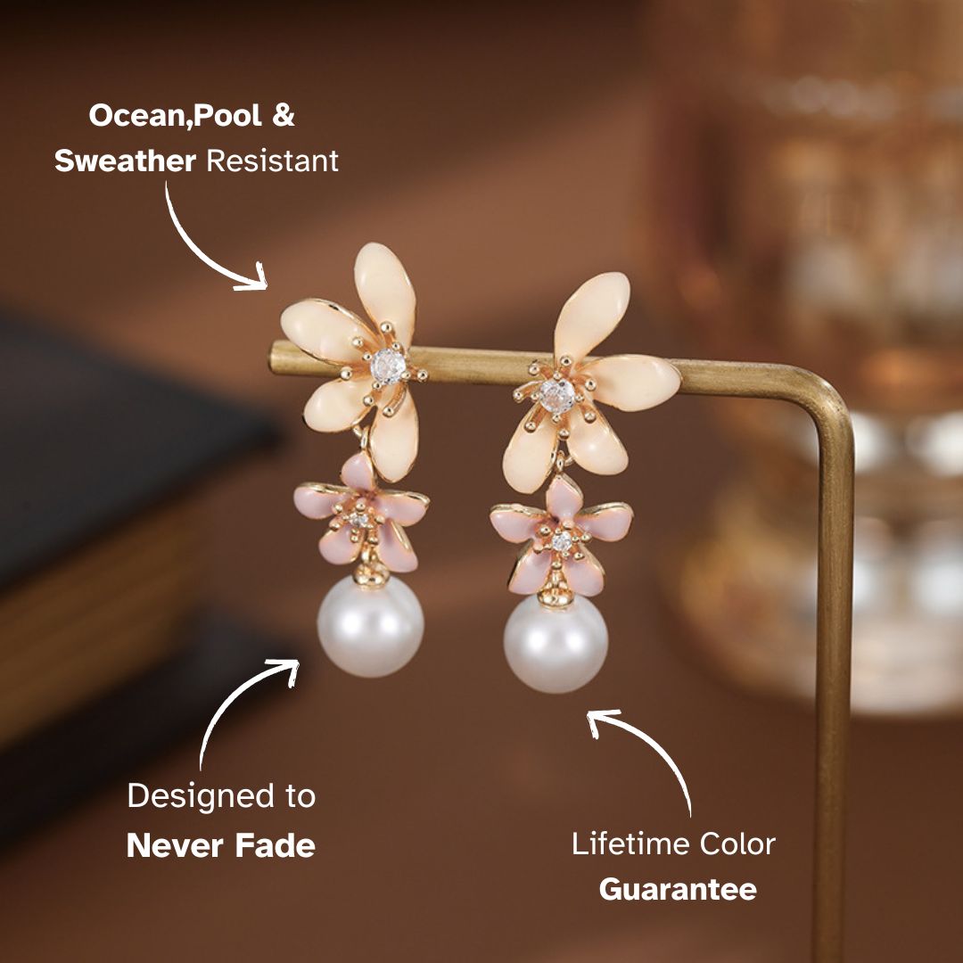 Feminine pearl drop earrings with a floral design, displayed on a gold stand with a blurred luxurious background, highlighting their elegance.