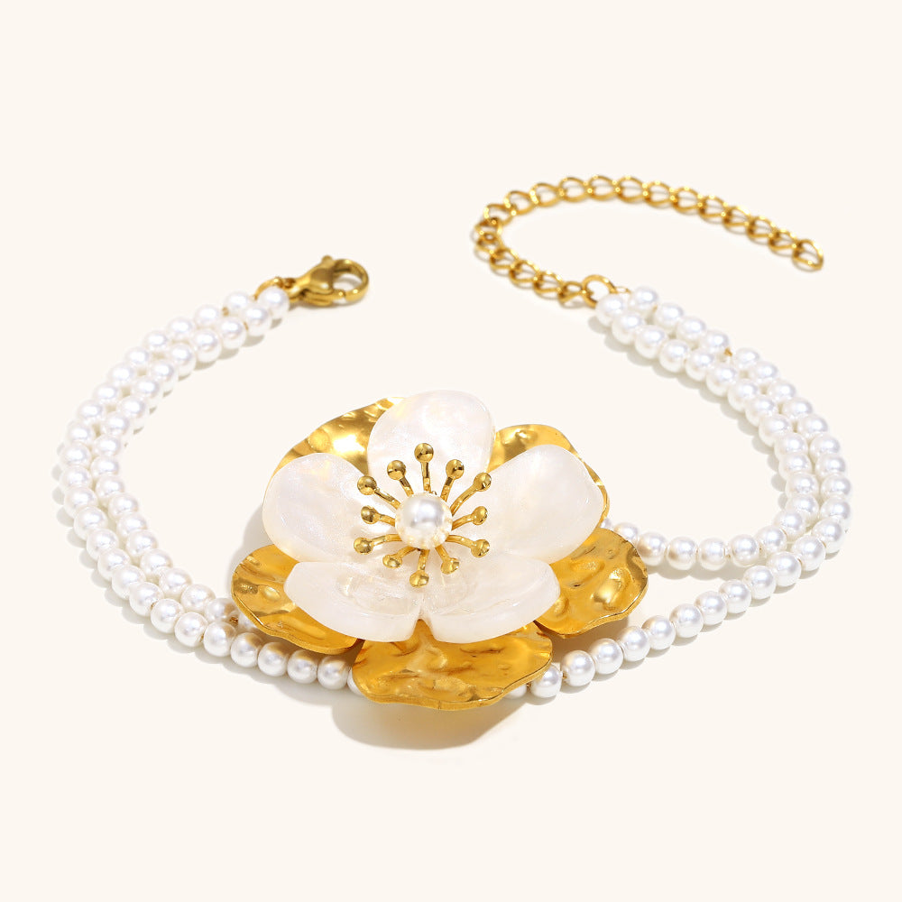 Gold floral bracelet with pearl beads and hammered metal petals