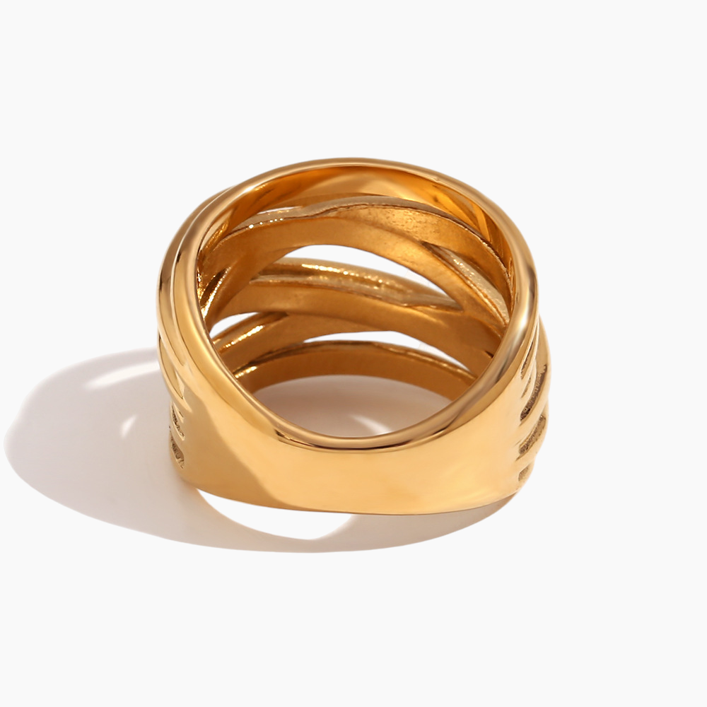 Gold ring with multiple bands on a white background