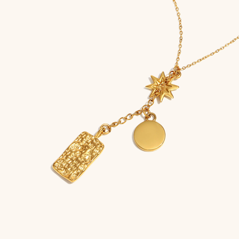 Close-up of boho layered pendant necklace with starburst and lunar medallion