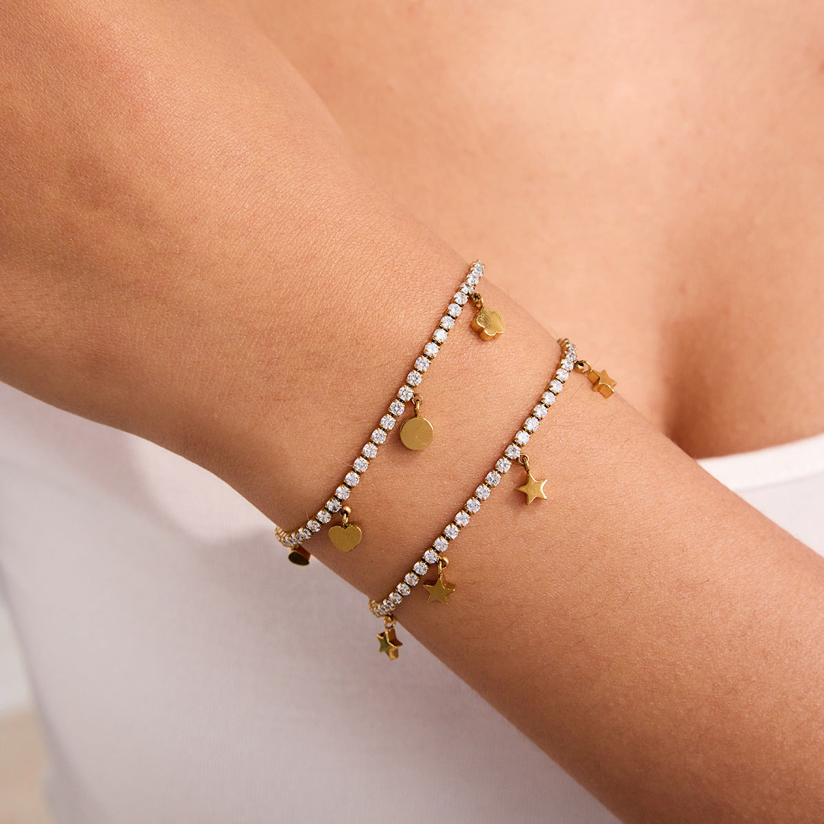 Adjustable gold charm bracelet styled on female wrist
