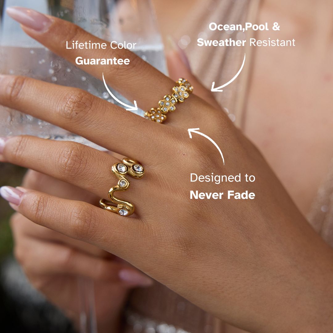 Woman holding glass wearing floral gold ring with shimmering stones