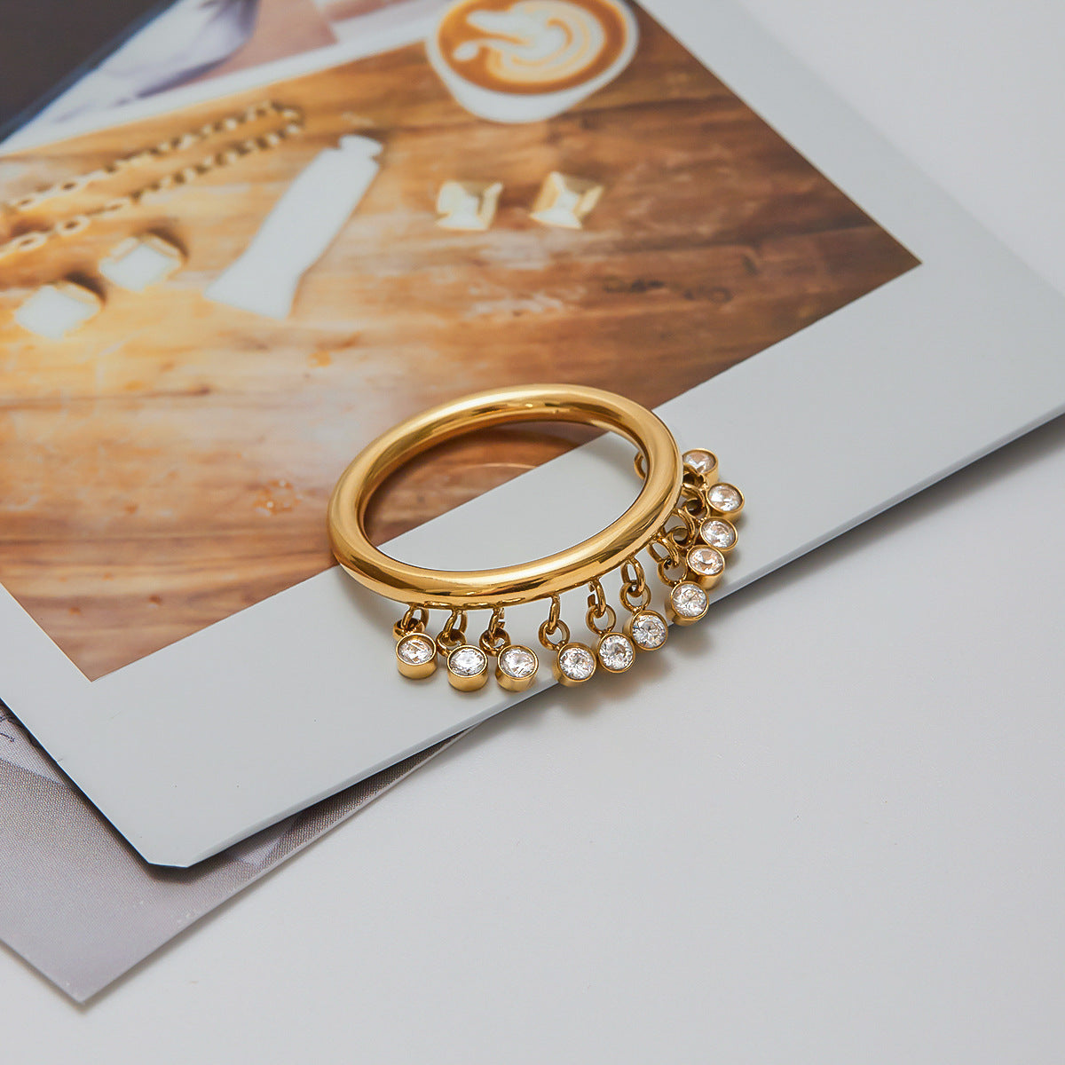 Gold charm ring on finger styled