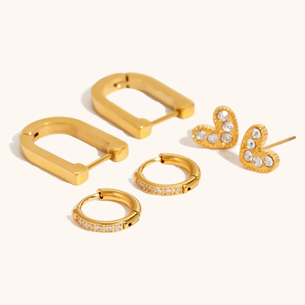 Gold heart-shaped stud earrings with sparkling crystals, ideal for daily wear
