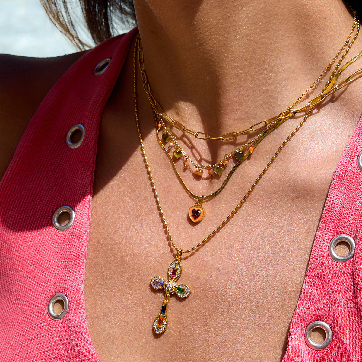 Model wearing heart charm necklace by the pool